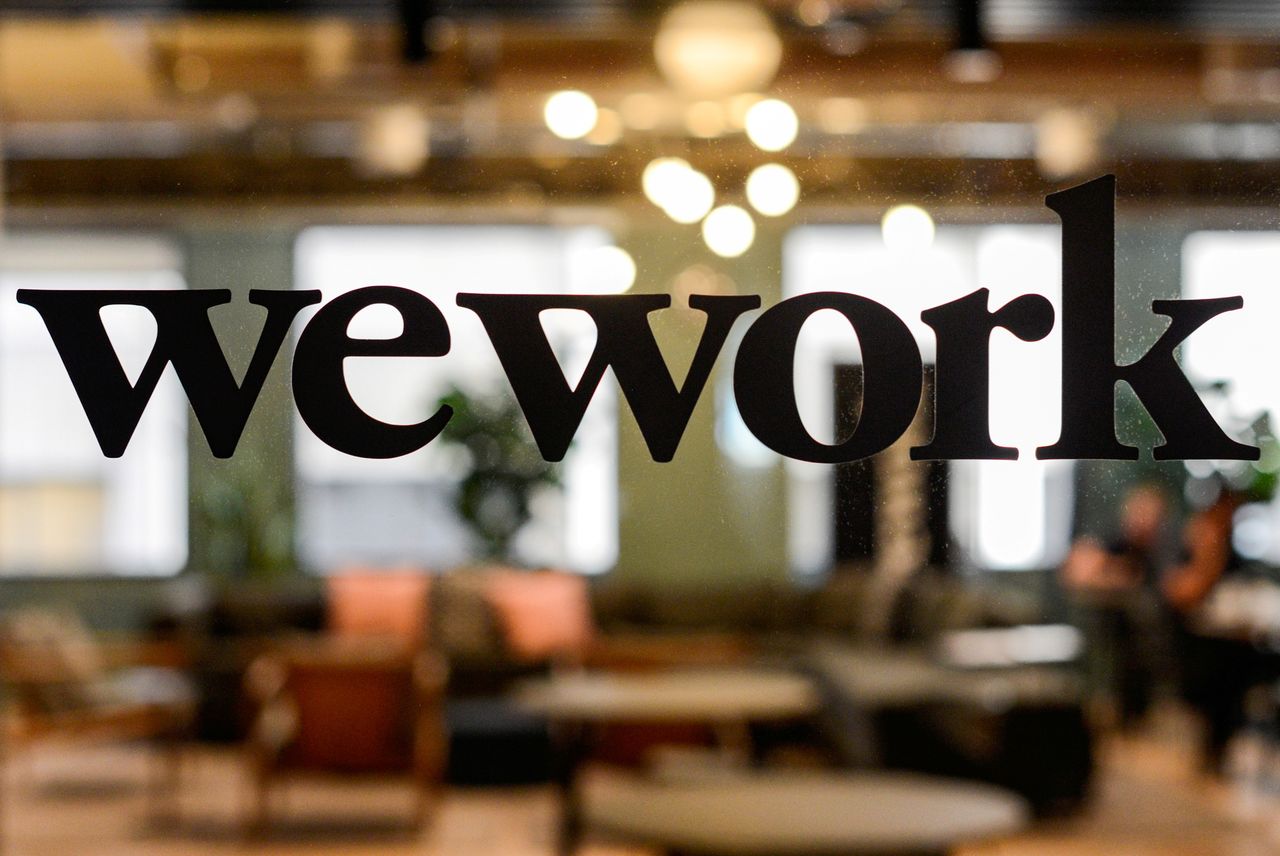 FILE PHOTO: FILE PHOTO: A WeWork logo is seen at a WeWork office in San Francisco, California, U.S. September 30, 2019.  REUTERS/Kate Munsch/File Photo