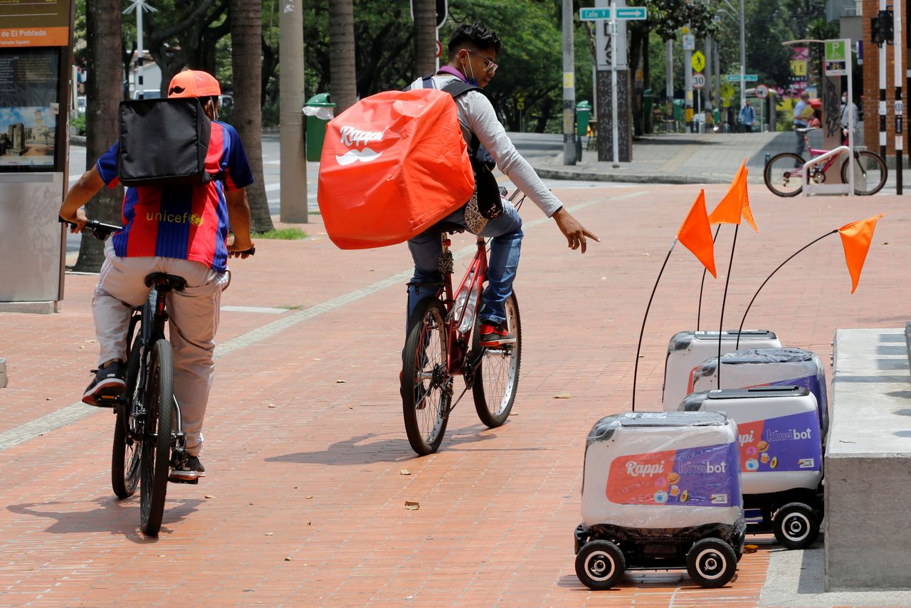 FILE PHOTO: Rappi delivery workers observe delivery robots from the Colombian company Rappi, amid the coronavirus disease (COVID-19) outbreak in Medellin, Colombia April 17, 2020. REUTERS/David Estrada