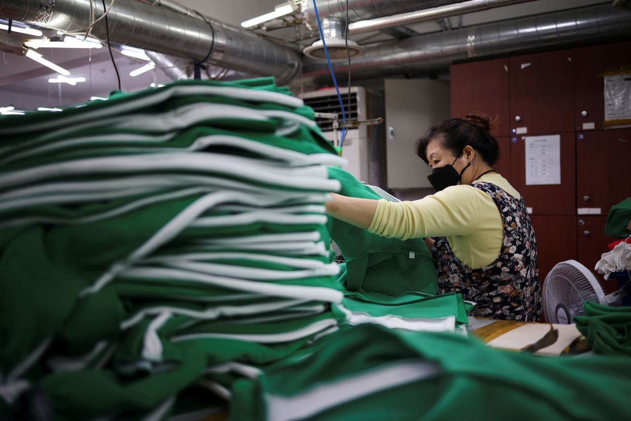 A woman works on tracksuits inspired by Netflix series "Squid Game" at a clothing factory in Seoul, South Korea, October 21, 2021. Picture taken on October 21, 2021. REUTERS/Kim Hong-Ji