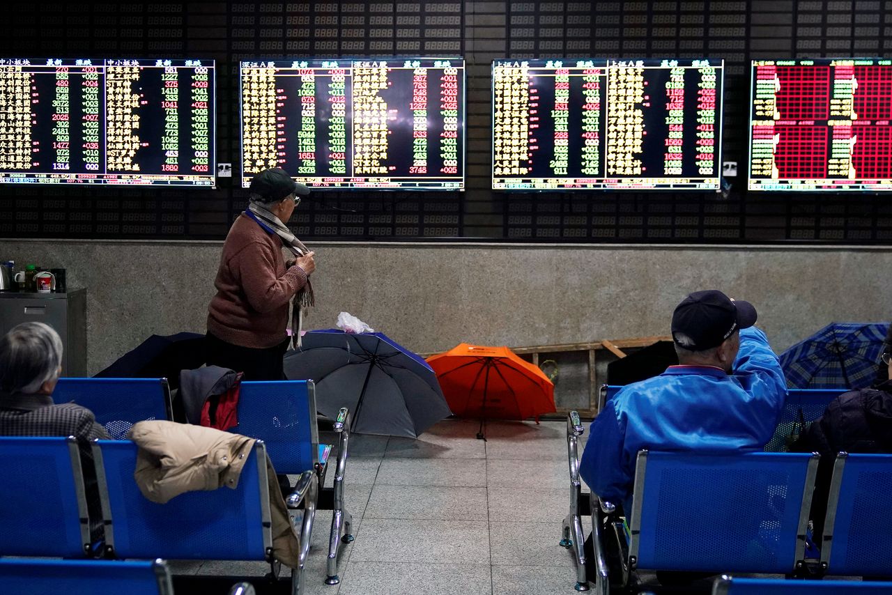 Investors look at screens showing stock information at a brokerage house in Shanghai, China January 16, 2020. REUTERS/Aly Song