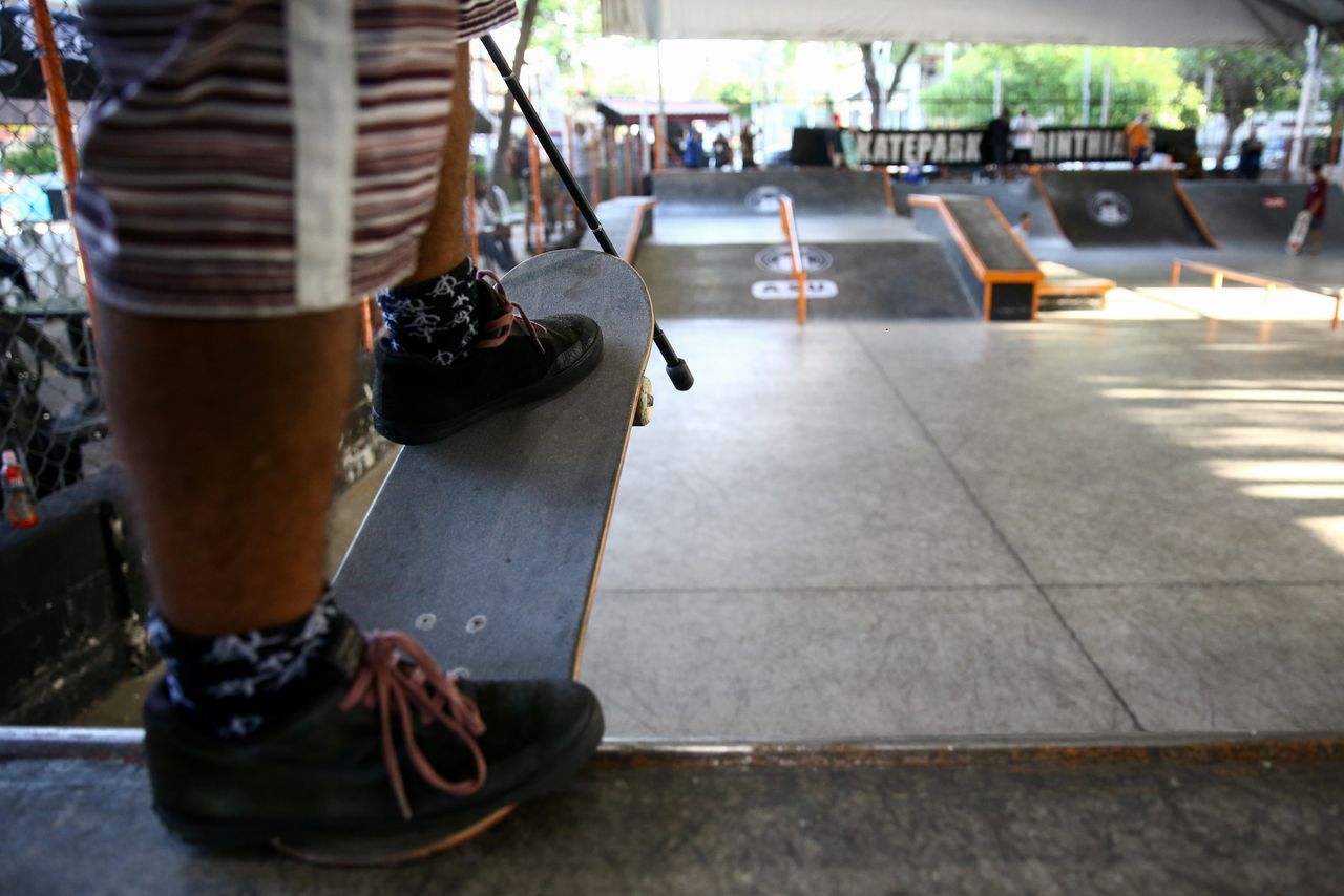 A competitor holds his cane and skateboard as he waits for his turn at the first Paraskate Tour Circuit, a competition for skateboarders with disabilities, in Sao Paulo, Brazil October 23, 2021. REUTERS/Carla Carniel