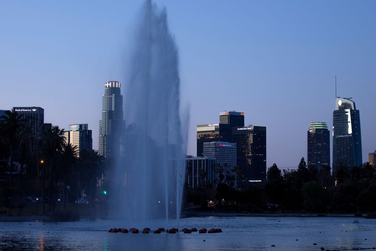 FILE PHOTO: The city skyline is shown at dawn from Echo Park Lake during the outbreak of the coronavirus disease (COVID-19) in Los Angeles, California, U.S., March 24, 2021. REUTERS/Mike Blake/File Photo