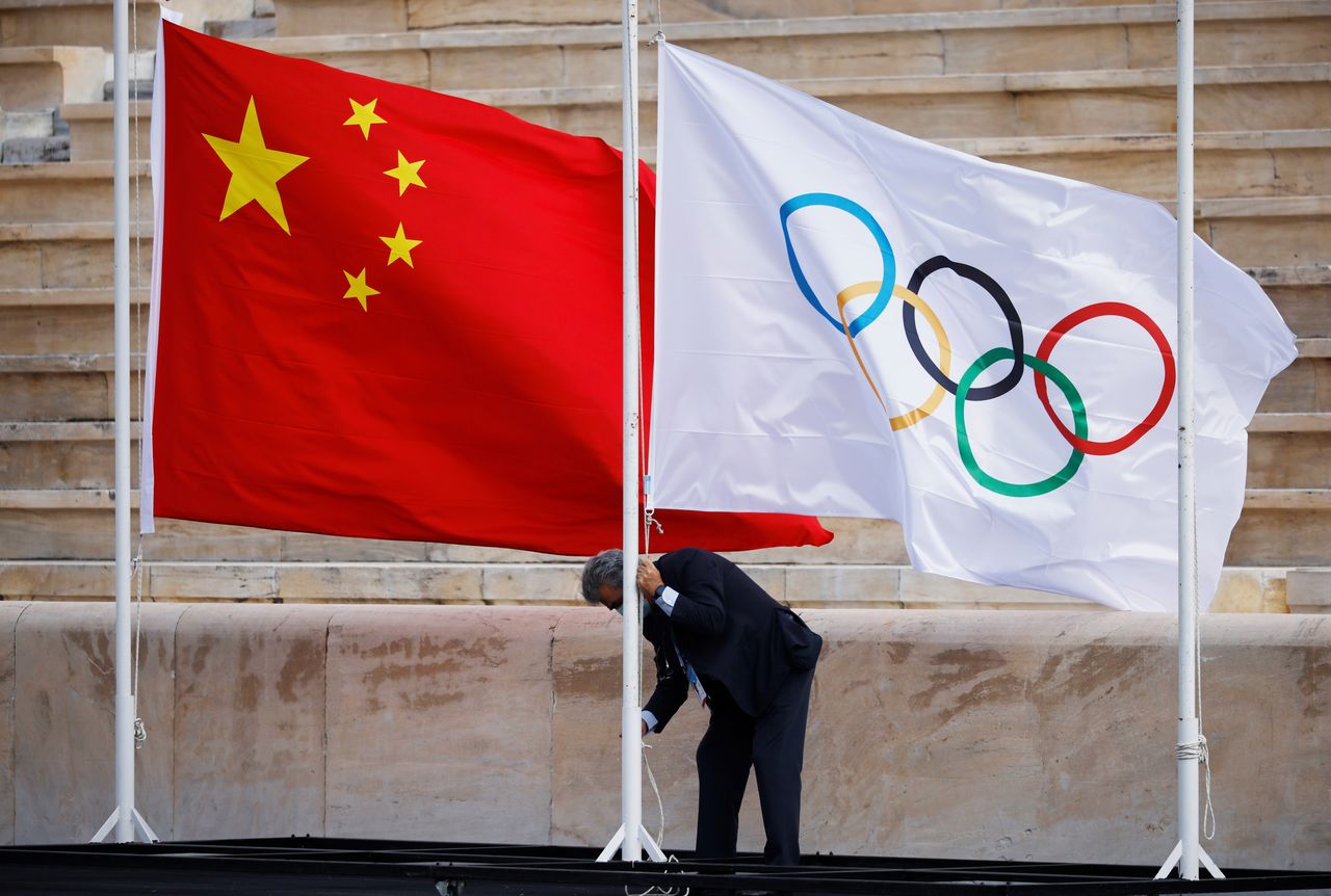 FILE PHOTO: Winter Olympics - Flame handover ceremony in Athens for the Beijing 2022 Winter Olympics - Panathenaic Stadium, Athens, Greece - October 19, 2021 The flags of China and the Olympics are seen being raised before the ceremony REUTERS/Alkis Konstantinidis/File Photo