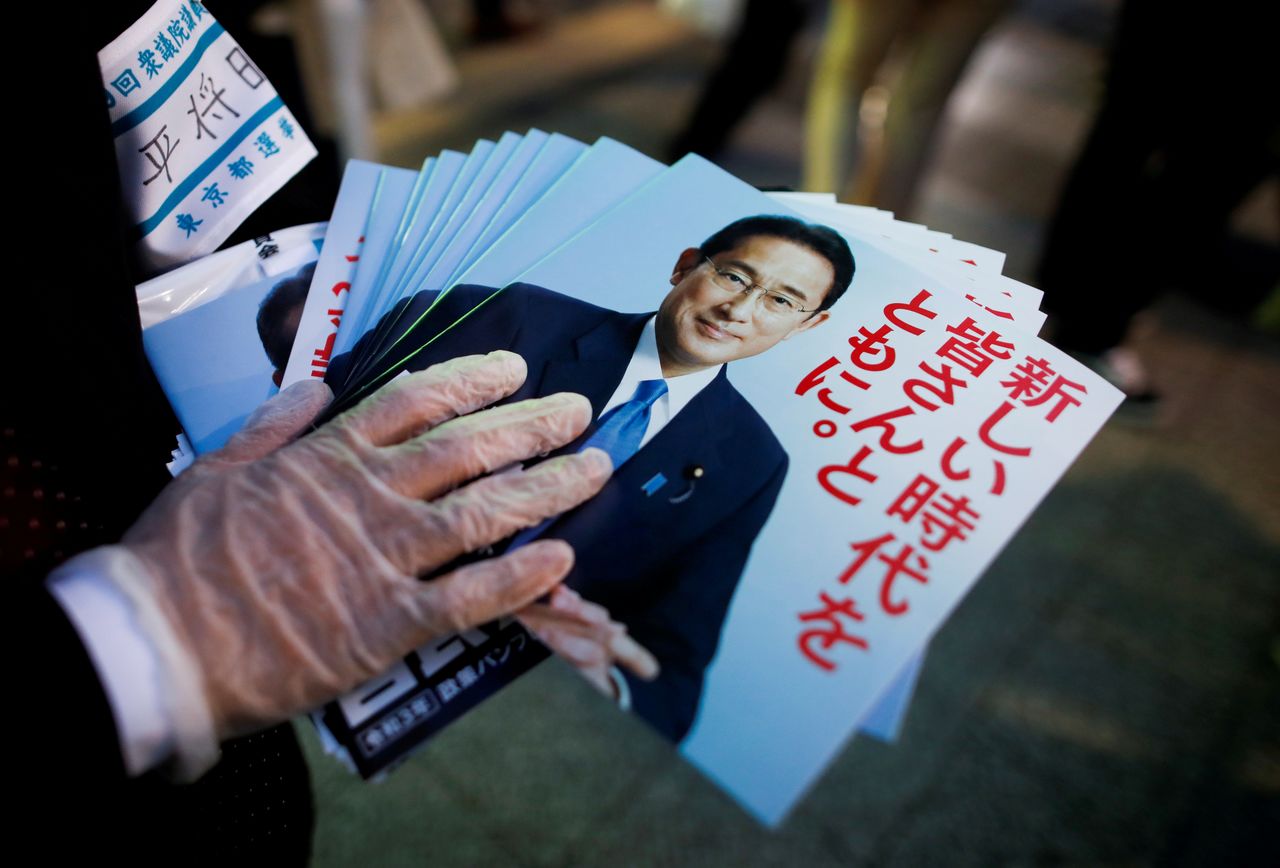 FILE PHOTO: An election campaign staff member holds leaflets of Japan