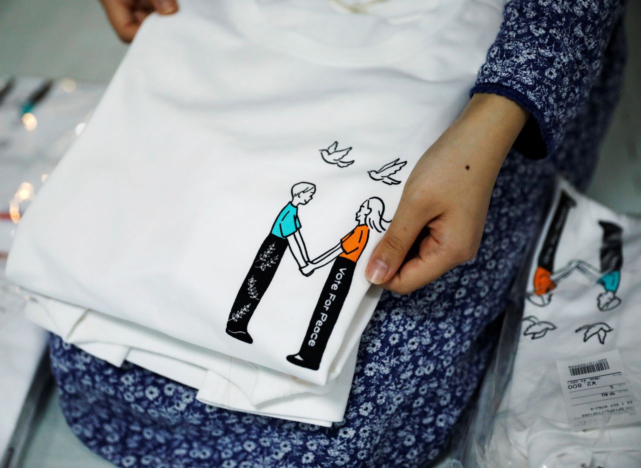 Youth activist and a member of "No Youth No Japan", Ayumi Adachi (20), carries out shipping work of T-shirts for a campaign to urge young people to vote during elections, at her house in Tokyo, Japan October 20, 2021. REUTERS/Issei Kato