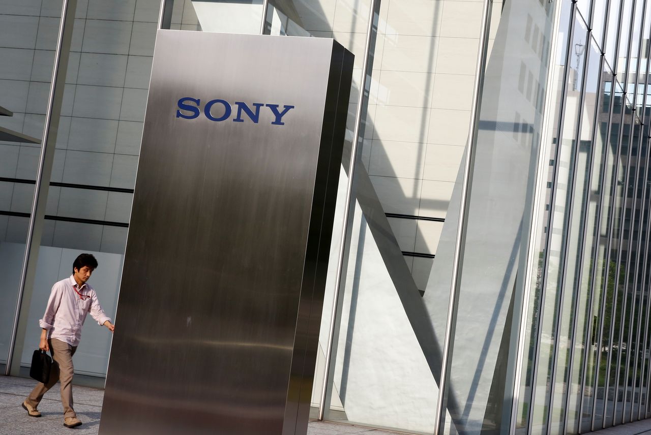 FILE PHOTO: A man walks past the Sony brand logo outside the headquarters of Sony Corp in Tokyo, Japan, May 24, 2016. REUTERS/Thomas Peter