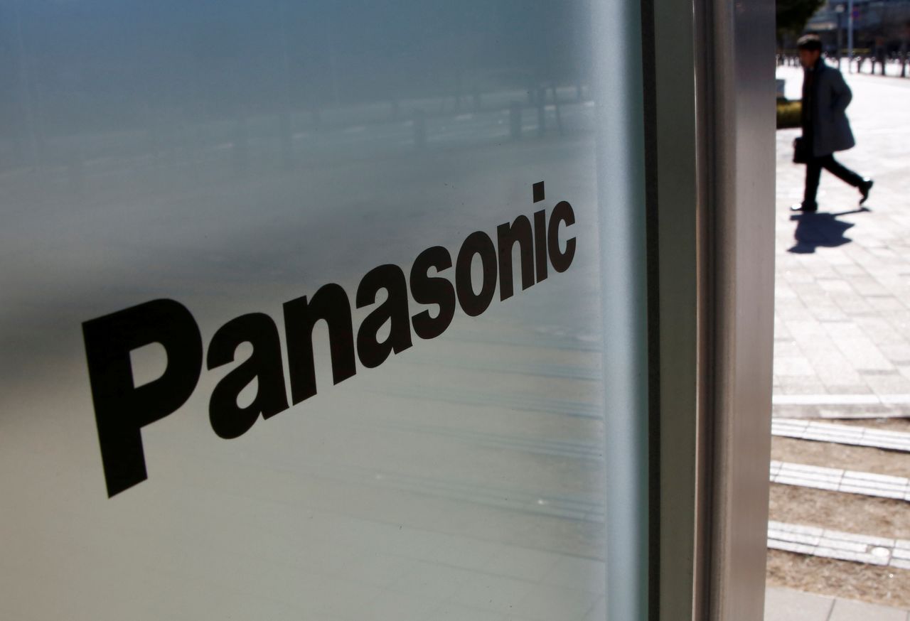 FILE PHOTO: A man is seen next to Panasonic Corp