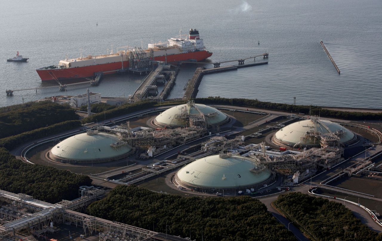 FILE PHOTO: Liquefied natural gas (LNG) storage tanks and a membrane-type tanker are seen at Tokyo Electric Power Co.