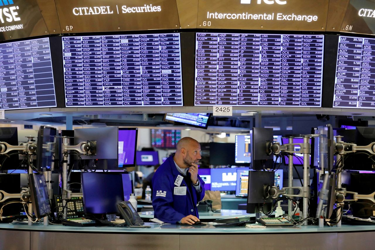FILE PHOTO: A trader works on the trading floor at the New York Stock Exchange (NYSE) in Manhattan, New York City, U.S., August 9, 2021. REUTERS/Andrew Kelly/File Photo
