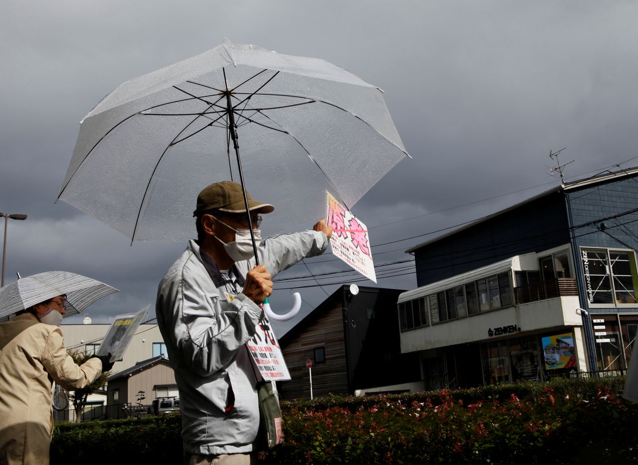 FILE PHOTO: An anti-nuclear activist demonstrates in front of the Tokyo Electric Power Company Holdings office in Niigata, Niigata Prefecture, Japan, October 21, 2021. REUTERS/Sakura Murakami