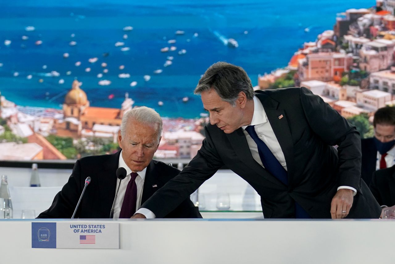U.S. Secretary of State Antony Blinken adjusts a microphone for U.S. President Joe Biden as he hosts an event on global supply chain resilience through the coronavirus disease (COVID-19) pandemic and recovery, on the sidelines of the G20 leaders