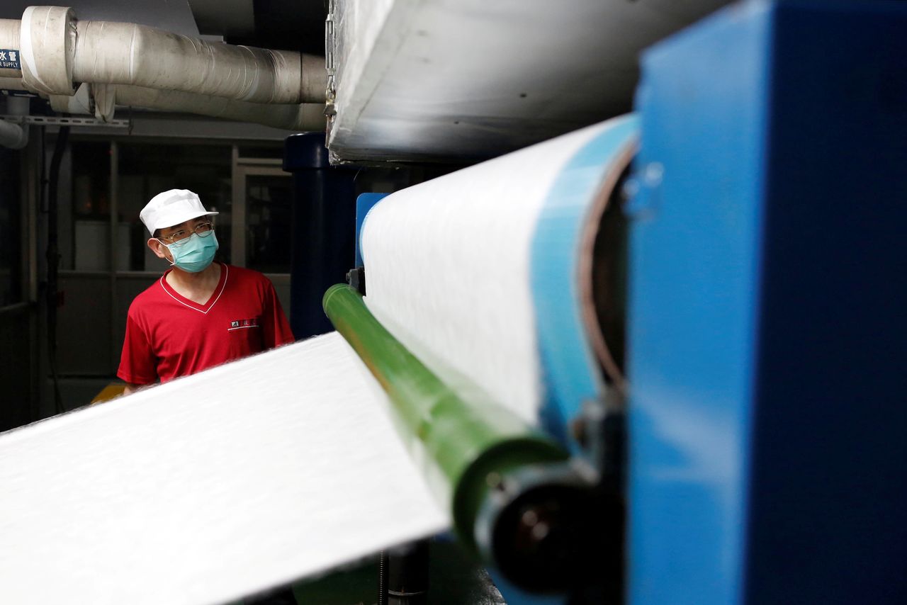 FILE PHOTO: Staff member works inside a non woven filter fabric factory, where the fabric is used to make surgical face masks, in Taoyuan, Taiwan, March 30, 2020. REUTERS/Ann Wang