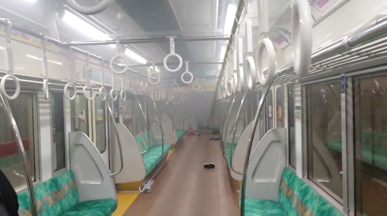 Smoke is seen in a carriage of a Tokyo train line following a knife and arson attack in Japan October 31, 2021 in this still image obtained from a social media video. Twitter/@SIZ33 via REUTERS