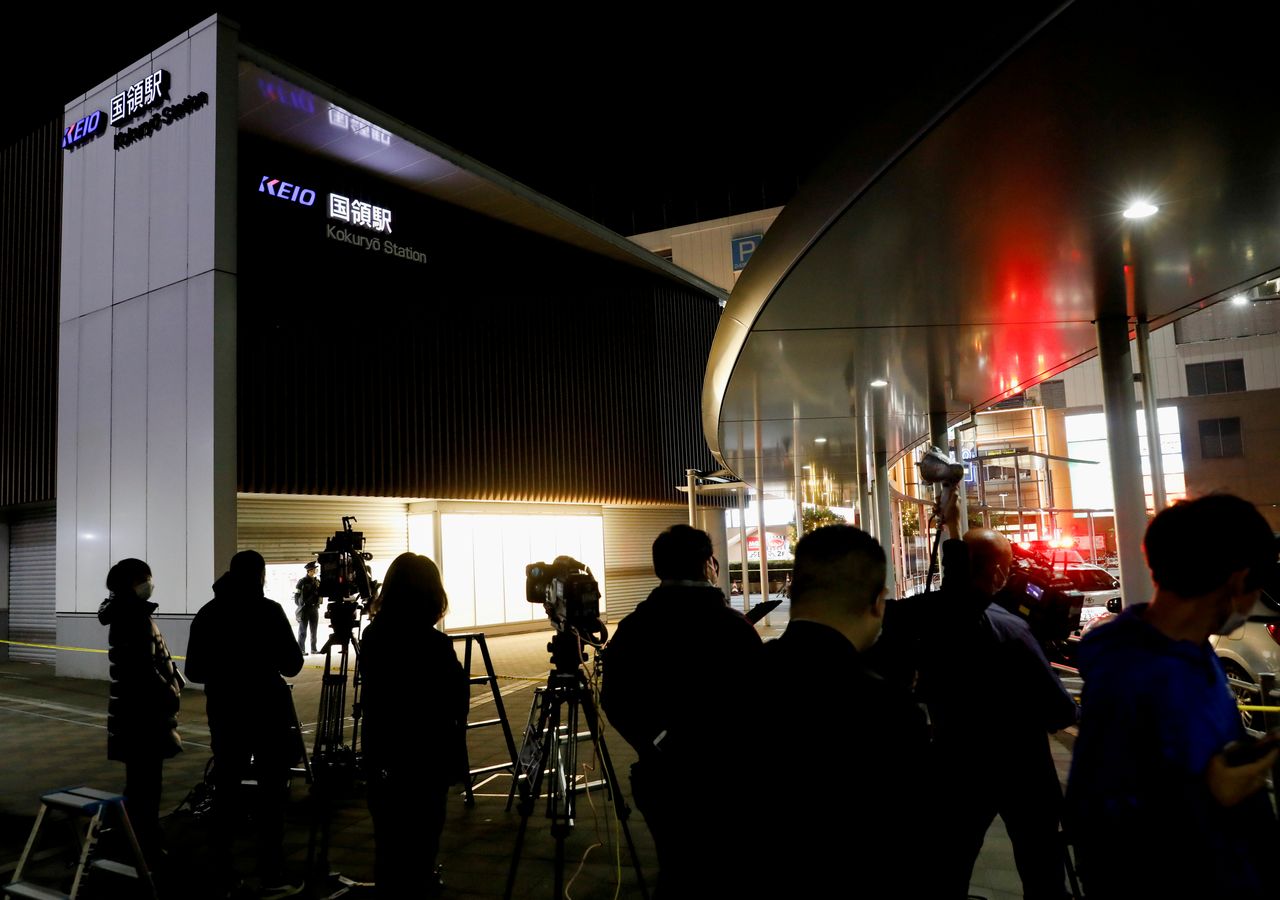 Media members gather outside Kokuryo station of the Keio Line train where a knife and arson attack occurred on a train in Tokyo, Japan November 1, 2021. REUTERS/Issei Kato