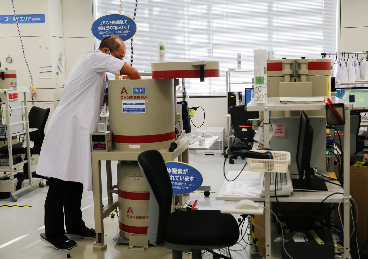 FILE PHOTO: A laboratory technician prepare tests for cesium levels in beef from cattle bred in Fukushima, at Fukushima Agricultural Technology Centre in Koriyama, Fukushima prefecture, Japan November 2, 2021. Picture taken November 2, 2021. REUTERS/Sakura Murakami
