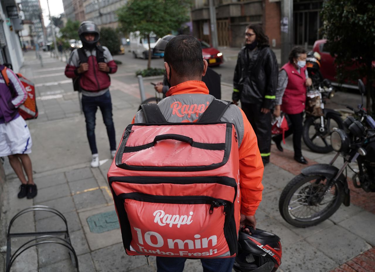 Guillermo, a delivery worker for mobile application Rappi waits on a street, in Bogota, Colombia November 8, 2021. REUTERS/Nathalia Angarita