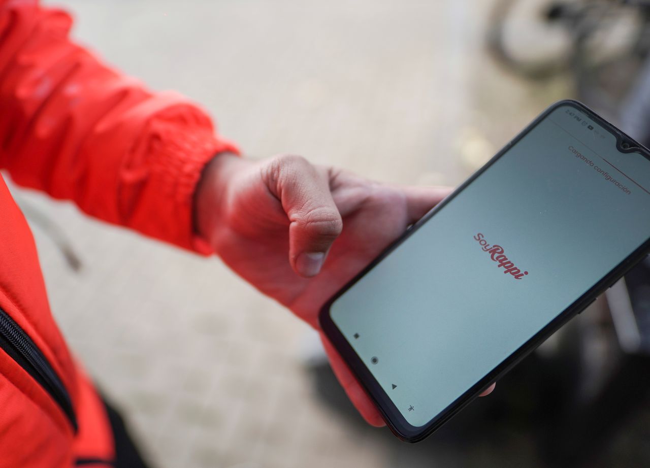 Yorkis Paz, delivery worker for mobile application Rappi, shows his mobile phone, in Bogota, Colombia November 8, 2021. REUTERS/Nathalia Angarita