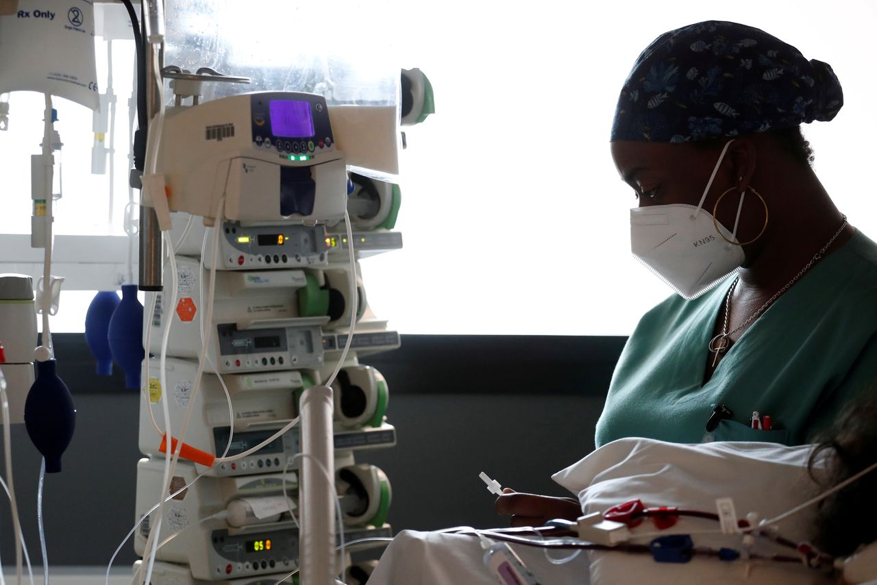 FILE PHOTO: A healthcare worker adjusts medical equipment in the Intensive Care Unit (ICU) at the Centre Cardiologique du Nord private hospital in Saint-Denis, near Paris, amid the coronavirus disease (COVID-19) pandemic in France, May 4, 2021. REUTERS/Benoit Tessier/File Photo