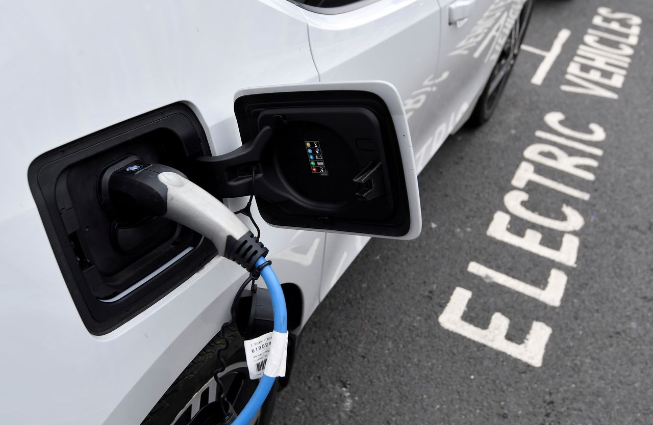 FILE PHOTO: An electric car is charged at a roadside EV charge point, London, October 19, 2021. REUTERS/Toby Melville