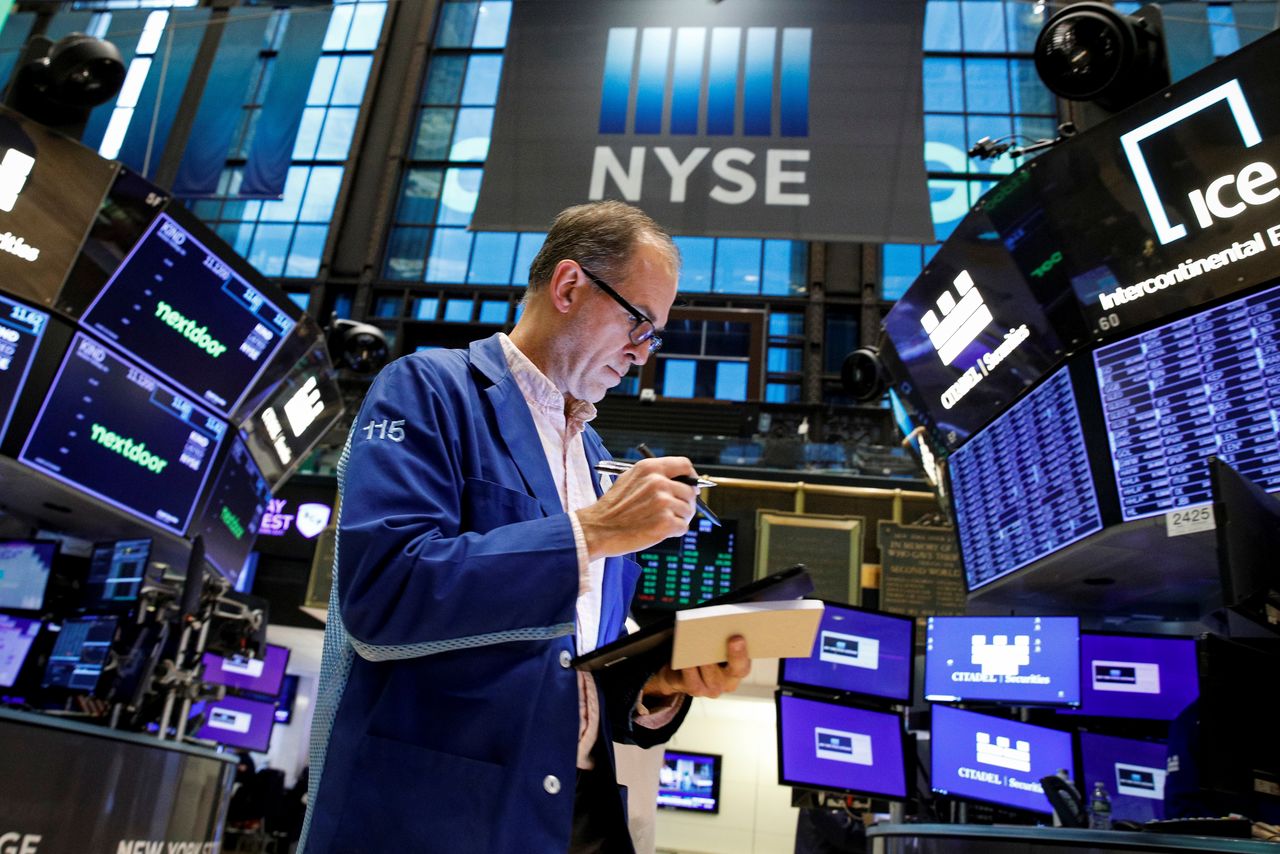 FILE PHOTO: A trader works on the floor of the New York Stock Exchange (NYSE) in New York City, U.S., November 8, 2021. REUTERS/Brendan McDermid