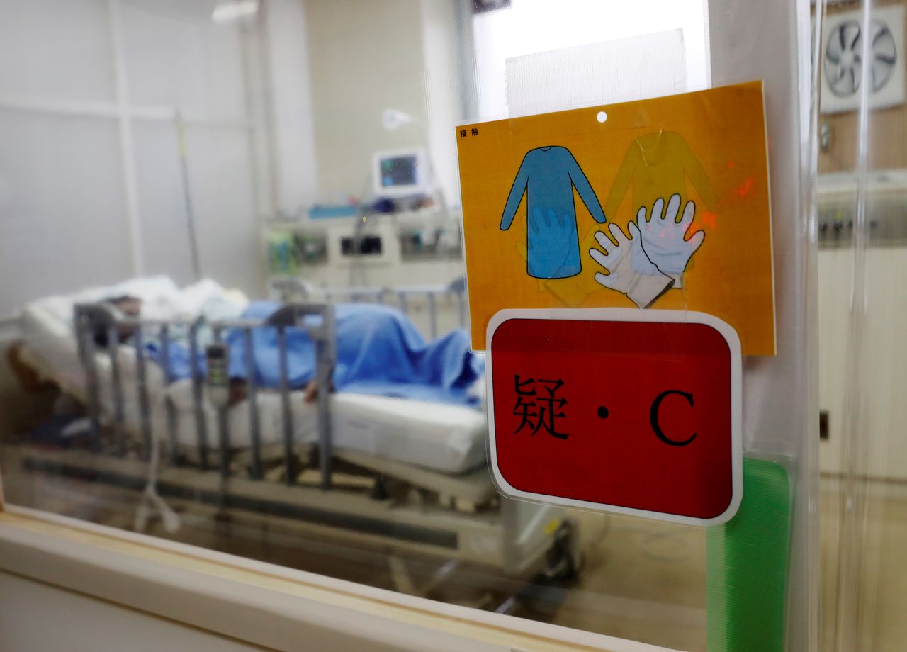FILE PHOTO: A patient is seen inside the ICU of Seibu Hospital, marked with a sign indicating that he is suspected of having COVID-19, in Yokohama, Japan June 18, 2020. Picture taken on June 18, 2020. REUTERS/Kim Kyung-Hoon