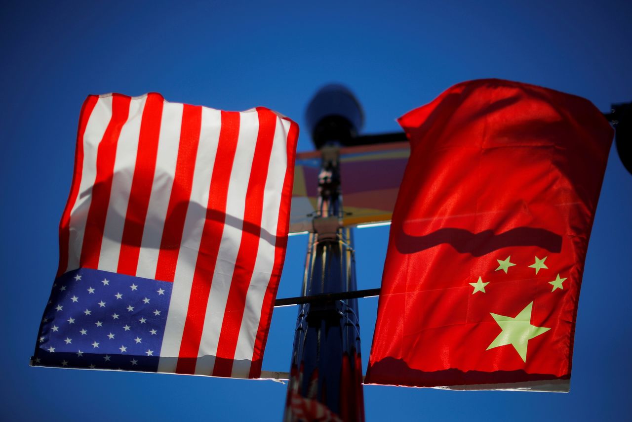 FILE PHOTO: The flags of the United States and China fly from a lamppost in the Chinatown neighborhood of Boston, Massachusetts, U.S., November 1, 2021. REUTERS/Brian Snyder/File Photo