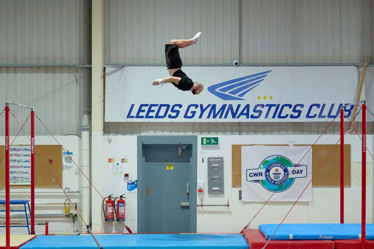 Ashley Watson, 29, from UK, attempts to set a new Guinness World Record for the "Farthest backflip between horizontal bars" in Leeds, Britain, November 12, 2021. Courtesy of Guinness World Records 2021/Michael Bowles/Handout via REUTERS