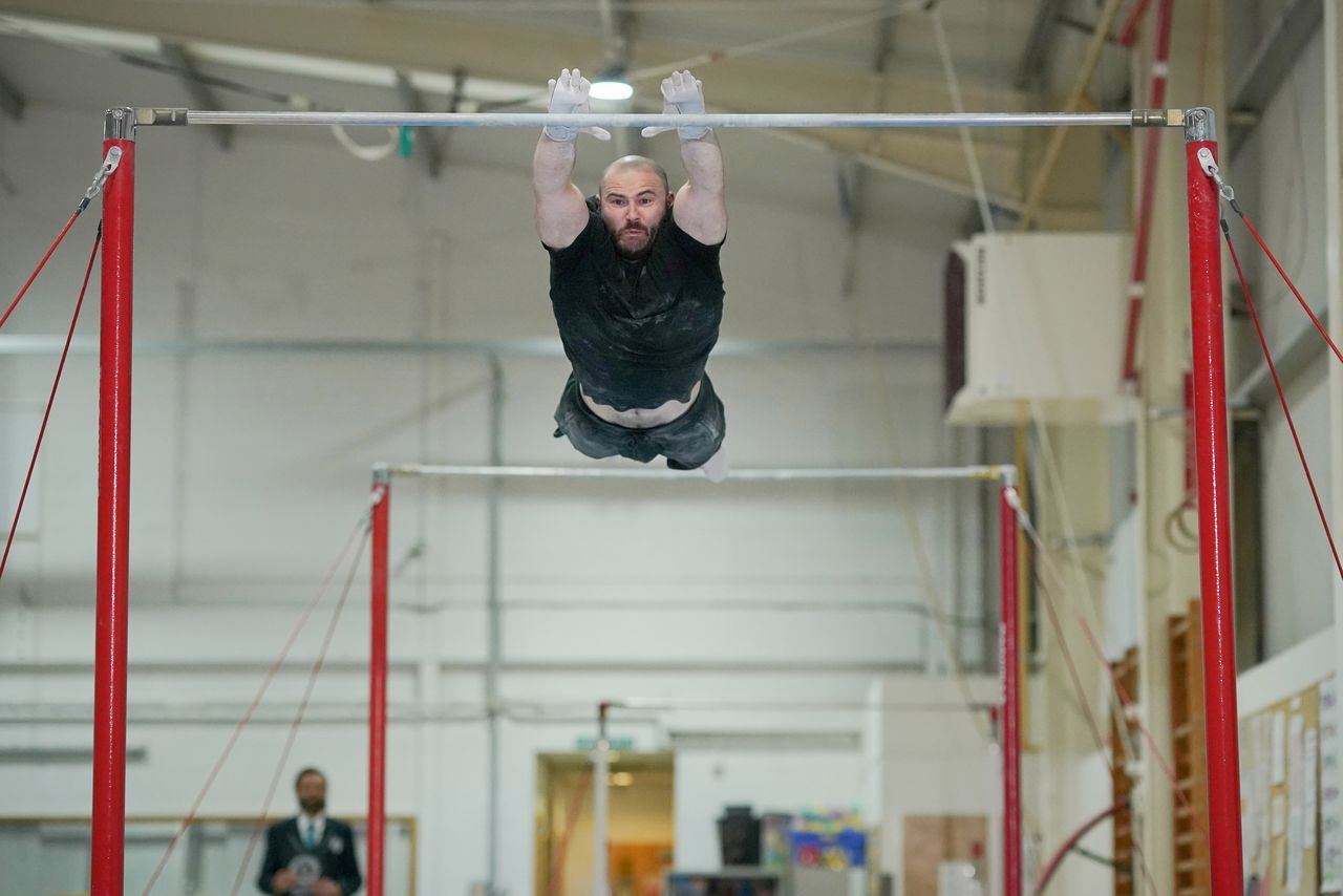 Ashley Watson, 29, from UK, attempts to set a new Guinness World Record for the "Farthest backflip between horizontal bars" in Leeds, Britain, November 12, 2021. Courtesy of Guinness World Records 2021/Michael Bowles/Handout via REUTERS