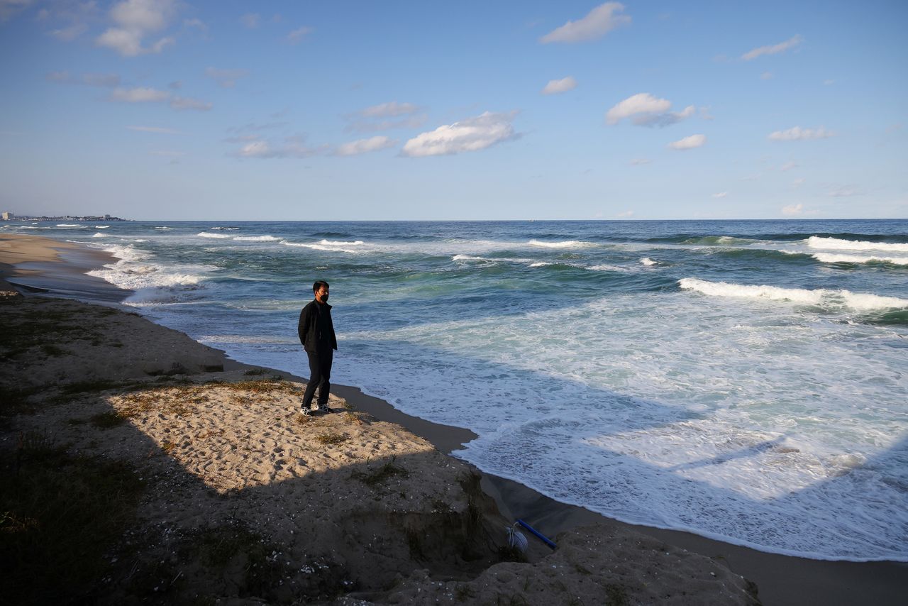 Choi Jong-min, who runs his own pension near Sacheon beach, stands in a place affected by erosion, where there used to be a long sand beach, at Sacheon beach in Gangneung, South Korea, November 3, 2021. REUTERS/Kim Hong-Ji