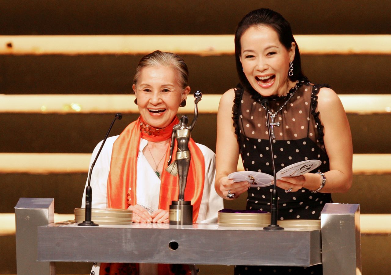 FILE PHOTO: Japanese Oscar-winning movie costume designer Emi Wada (L) and Hong Kong actress Cecilia Yip present an award at the 25th Hong Kong Film Awards, April 8, 2006. REUTERS/Paul Yeung/File Photo