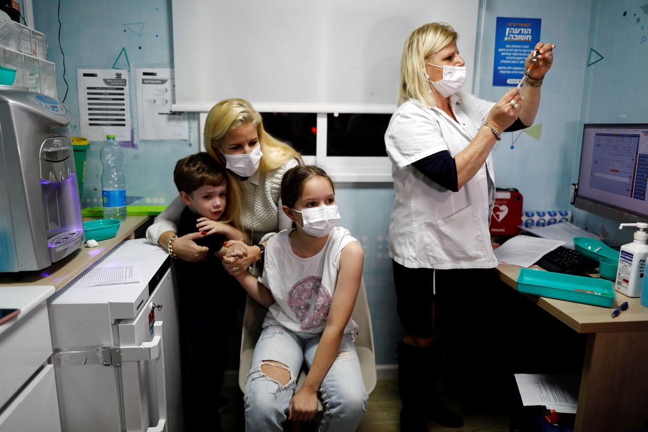 Gal, 11, waits to receive her first coronavirus disease (COVID-19) vaccination after country approves vaccinations for children aged 5-11, in Tel Aviv, Israel November 22, 2021. REUTERS/Corinna Kern