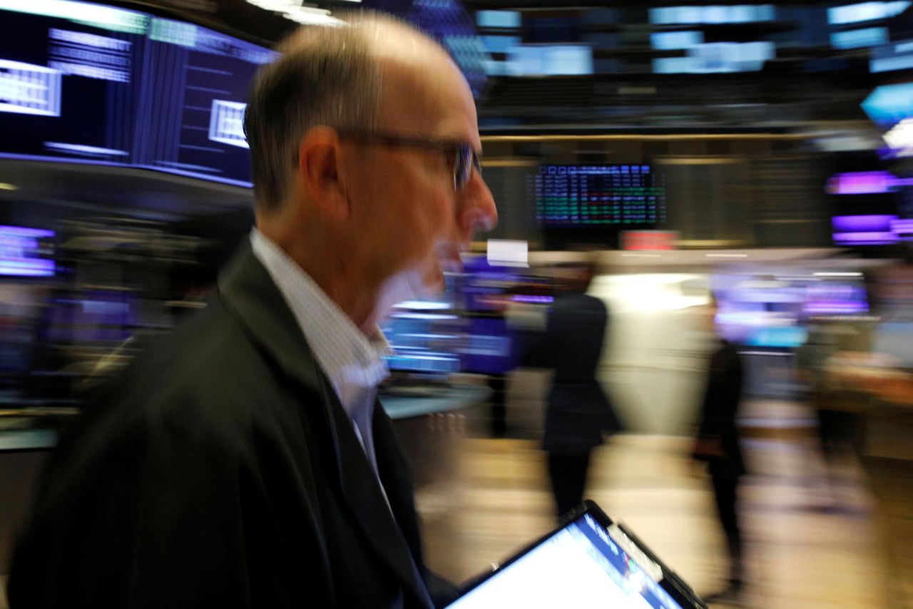Traders work on the floor of the New York Stock Exchange (NYSE) in New York City, U.S., October 18, 2021.  REUTERS/Brendan McDermid/Files