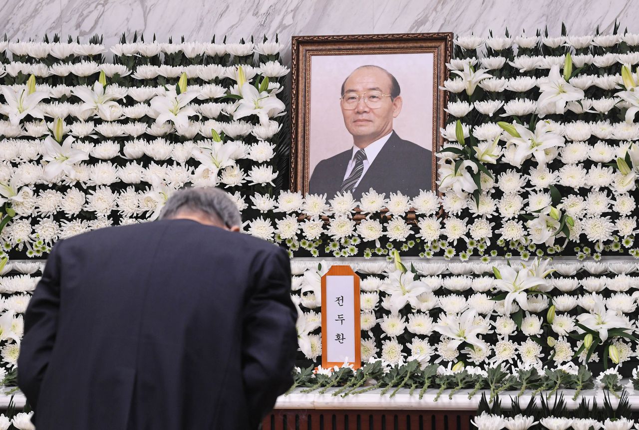 A man mourns during a funeral for late former South Korean President Chun Doo-hwan, who took office following a 1979 military coup, in Seoul, South Korea, November 23, 2021. Yonhap via REUTERS