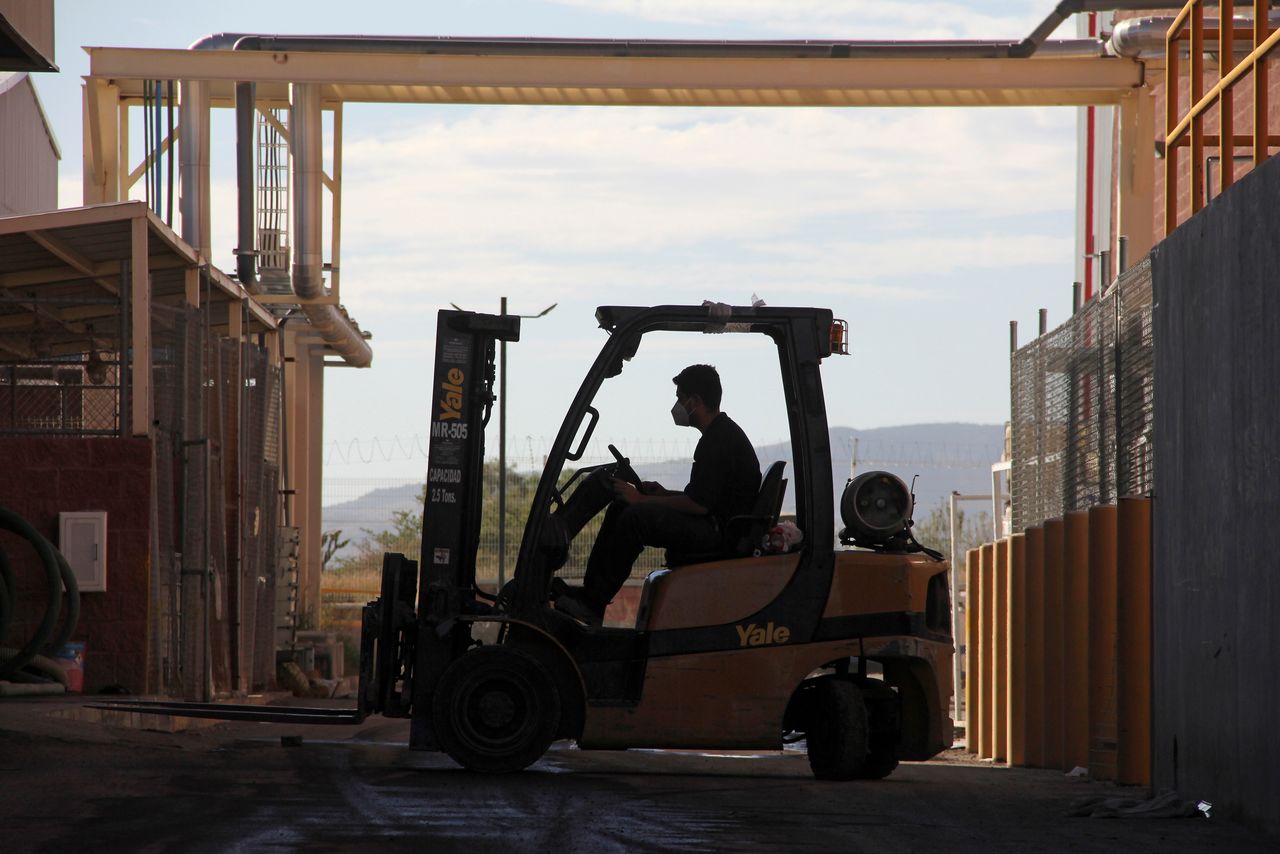 A worker operates a forklift at Minth plant, a manufacturer for the automotive industry, in Aguascalientes, Mexico November 9, 2021. REUTERS/Hugo Gomez