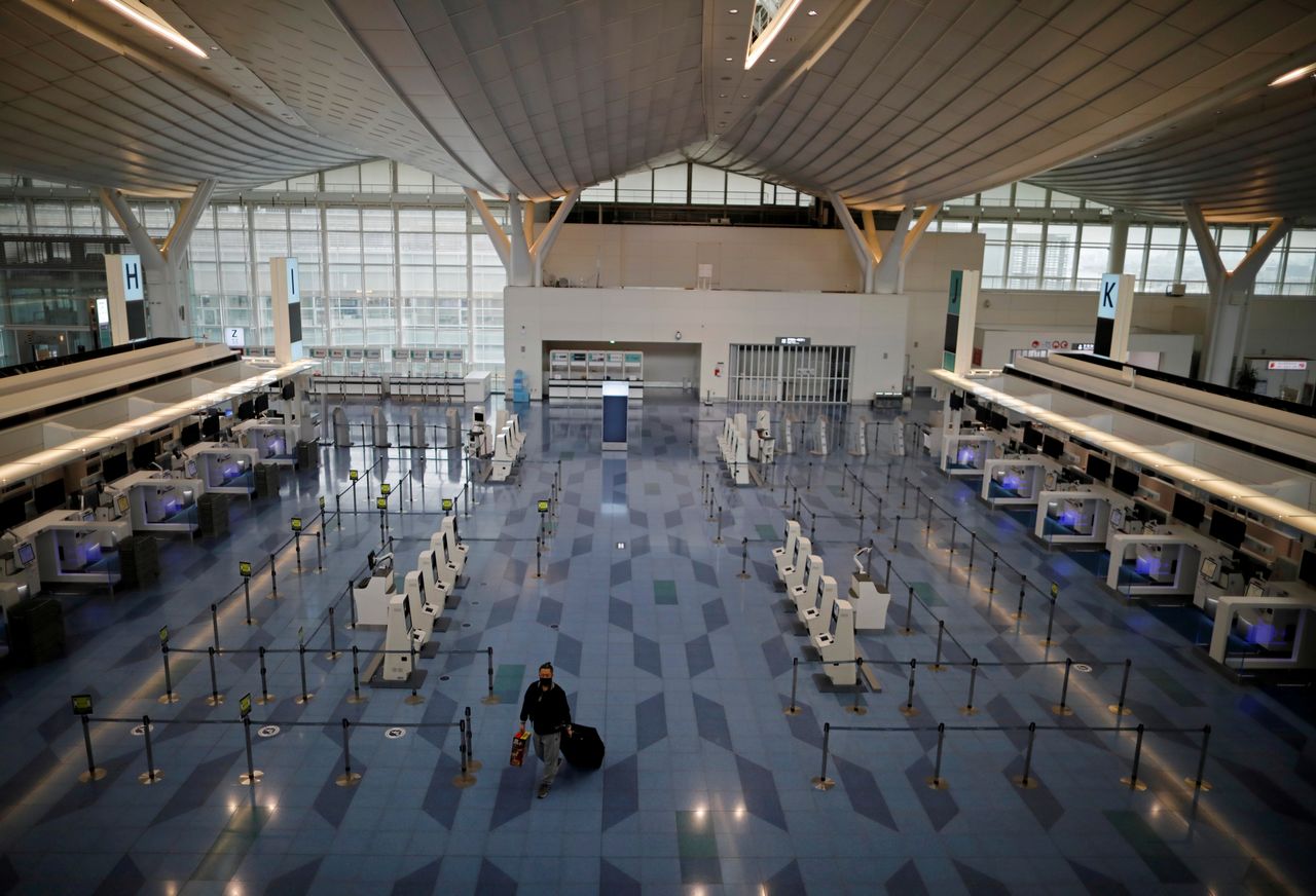 FILE PHOTO: A passenger is seen at the check-in area of the international flight terminal at Tokyo International Airport, commonly know as Haneda airport, amid the coronavirus disease (COVID-19) outbreak, in Tokyo, Japan December 28, 2020. REUTERS/Issei Kato