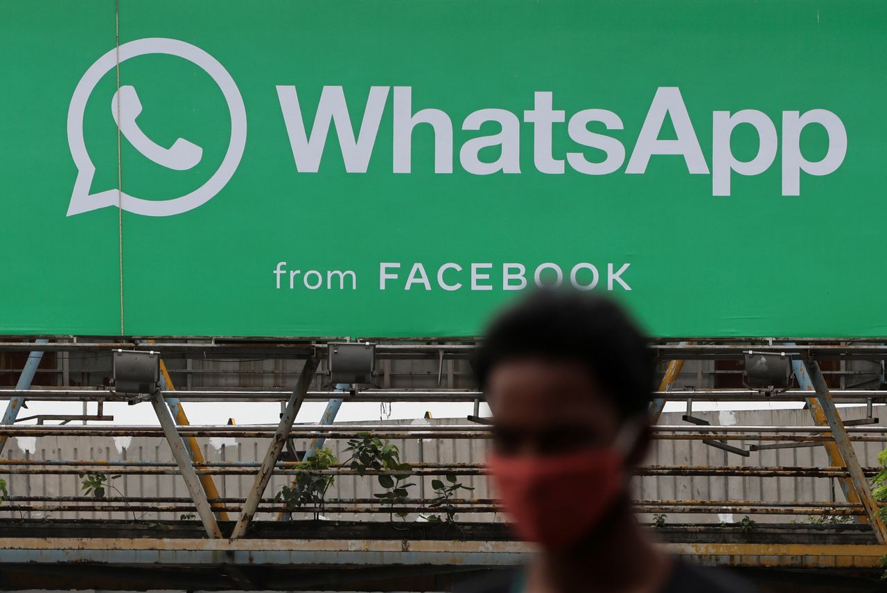 A man walks past a hoarding of the WhatsApp application installed at a skywalk in Mumbai, India, August 26, 2021. REUTERS/Francis Mascarenhas/Files