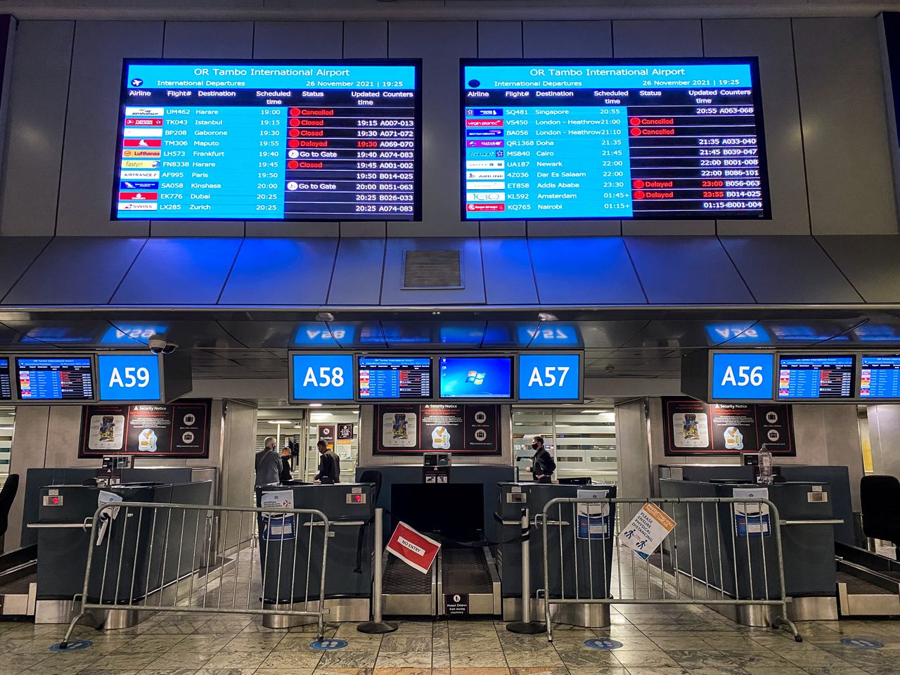 FILE PHOTO: Digital display boards show cancelled flights to London - Heathrow at O.R. Tambo International Airport in Johannesburg, South Africa, November 26, 2021. REUTERS/ Sumaya Hisham/File Photo