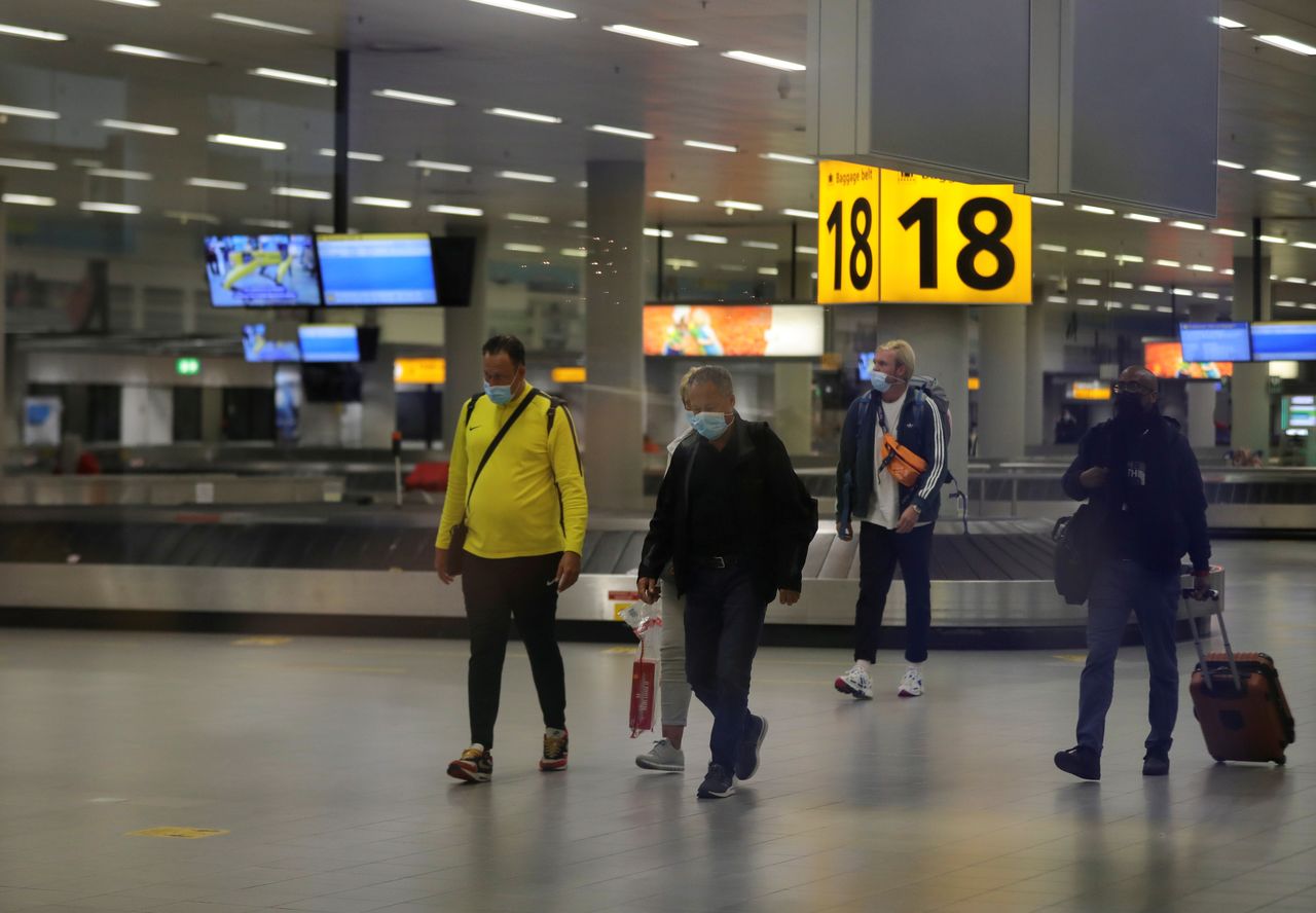 People walk inside Schiphol Airport after Dutch health authorities said that 61 people who arrived in Amsterdam on flights from South Africa tested positive for COVID-19, in Amsterdam, Netherlands, November 27, 2021. REUTERS/Eva Plevier