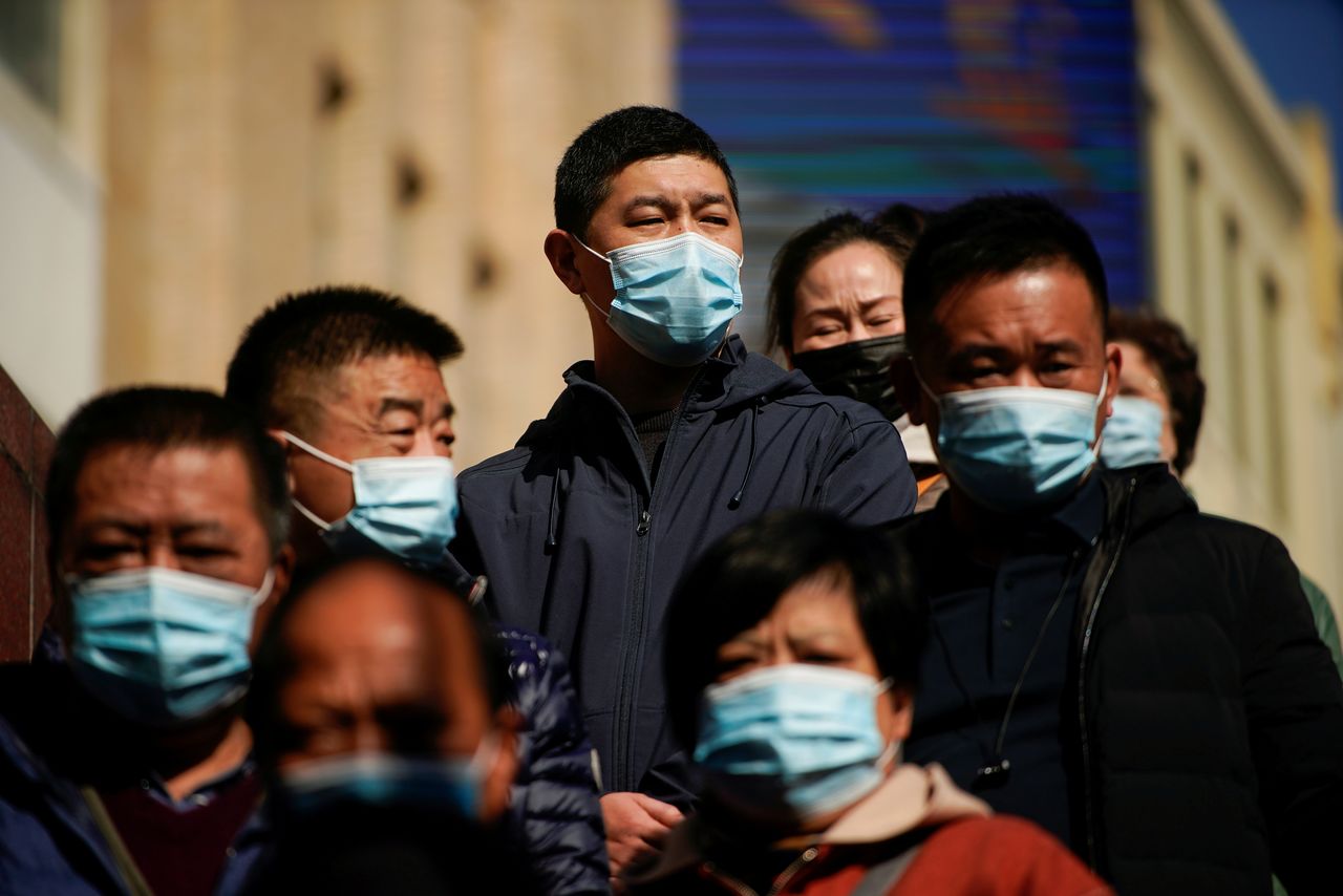 FILE PHOTO: People wearing protective masks are seen on a street, following new cases of the coronavirus disease (COVID-19), in Shanghai, China, November 24, 2021. Picture taken November 24, 2021. REUTERS/Aly Song/File Photo