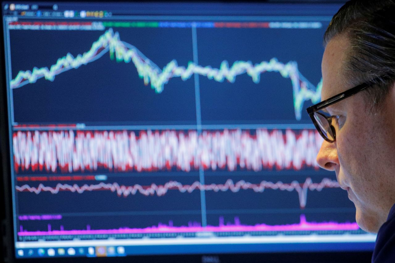 FILE PHOTO: A trader works inside a booth on the floor of the New York Stock Exchange (NYSE) in New York City, U.S., November 8, 2021. REUTERS/Brendan McDermid/File Photo