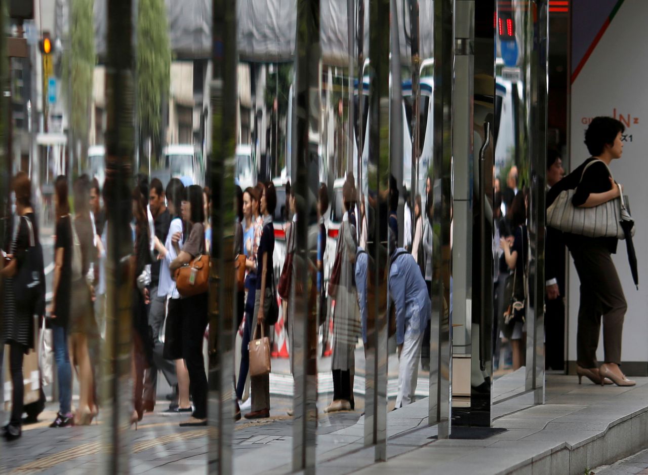 FILE PHOTO: People are reflected in the windows of a dapartment store in a shopping district in Tokyo, Japan June 29, 2016. REUTERS/Toru Hanai/File Photo