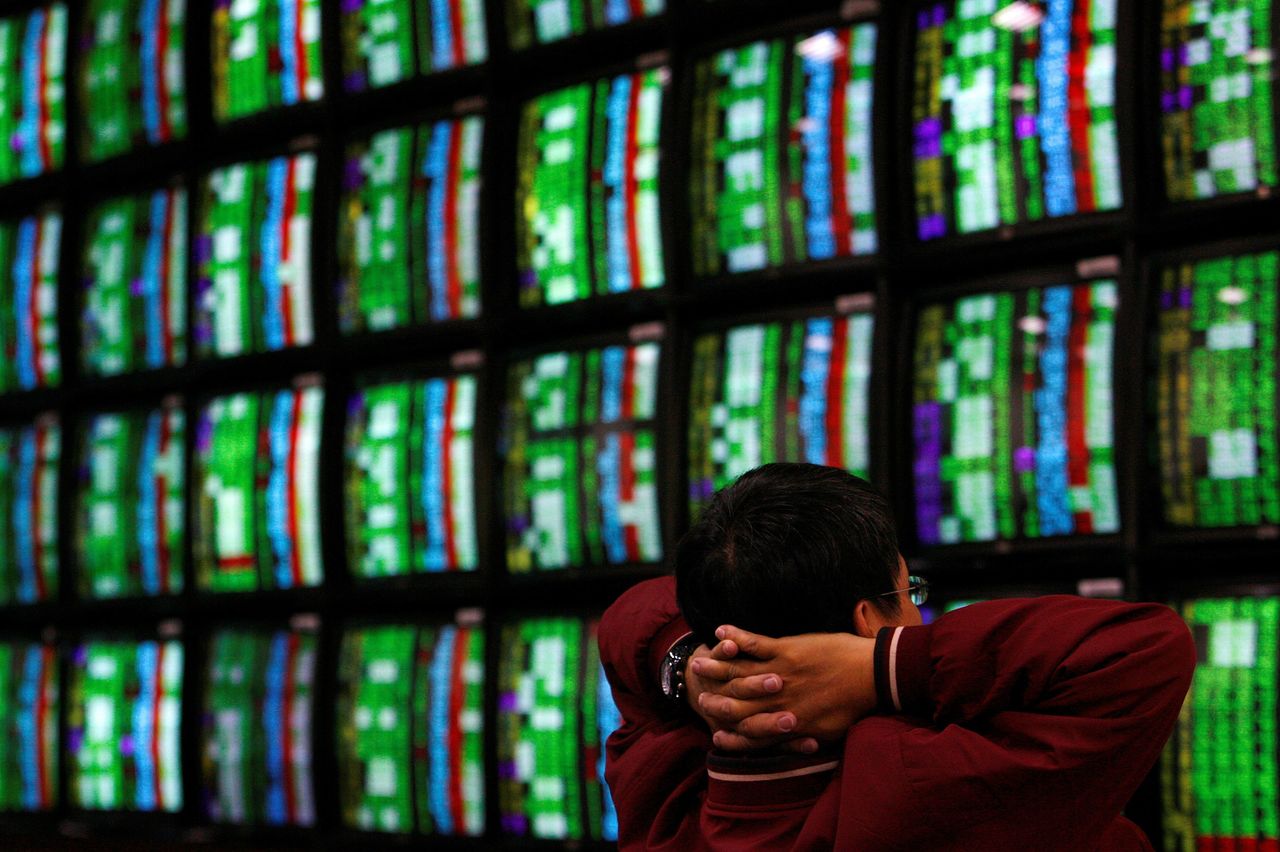 FILE PHOTO: A man looks at stock market monitors in Taipei January 22, 2008. REUTERS/Nicky Loh