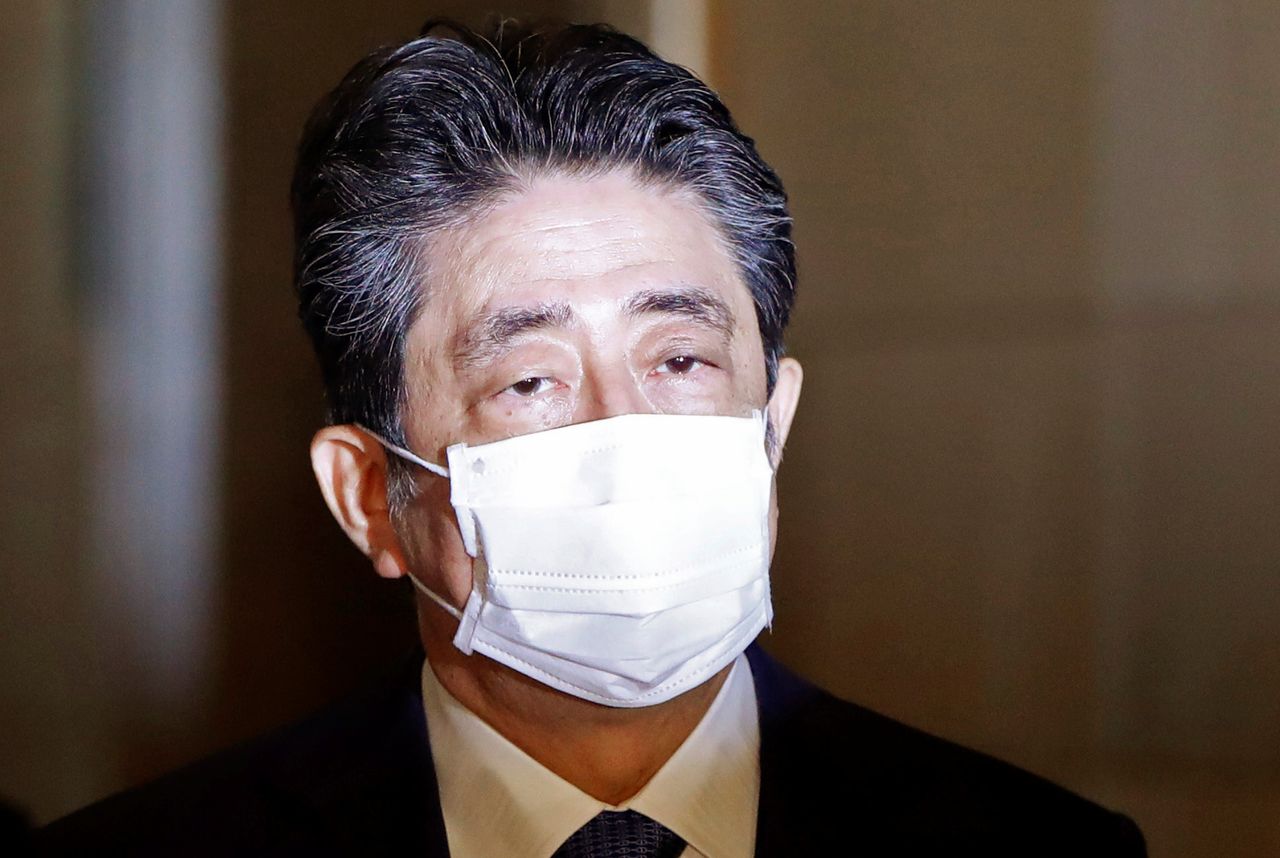 FILE PHOTO: Former Japanese Prime Minister Shinzo Abe arrives at the parliament building to attend a parliament session to face questioning over a possible violation of election funding laws, in Tokyo, Japan December 25, 2020.  REUTERS/Issei Kato
