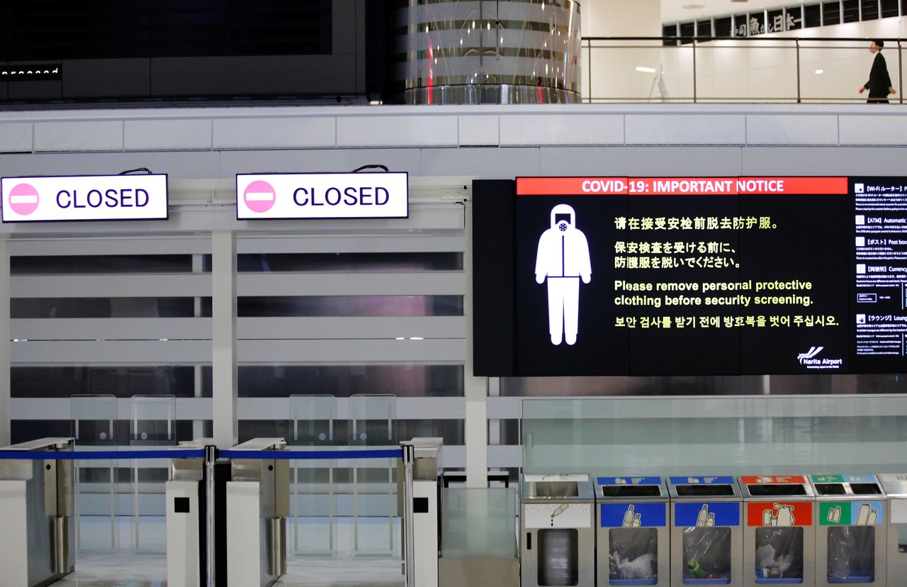 A notice about COVID-19 safety measures is pictured next to closed doors at a departure hall of Narita international airport on the first day of closed borders to prevent the spread of the new coronavirus Omicron variant in Narita, east of Tokyo, Japan, November 30, 2021. REUTERS/Kim Kyung-Hoon