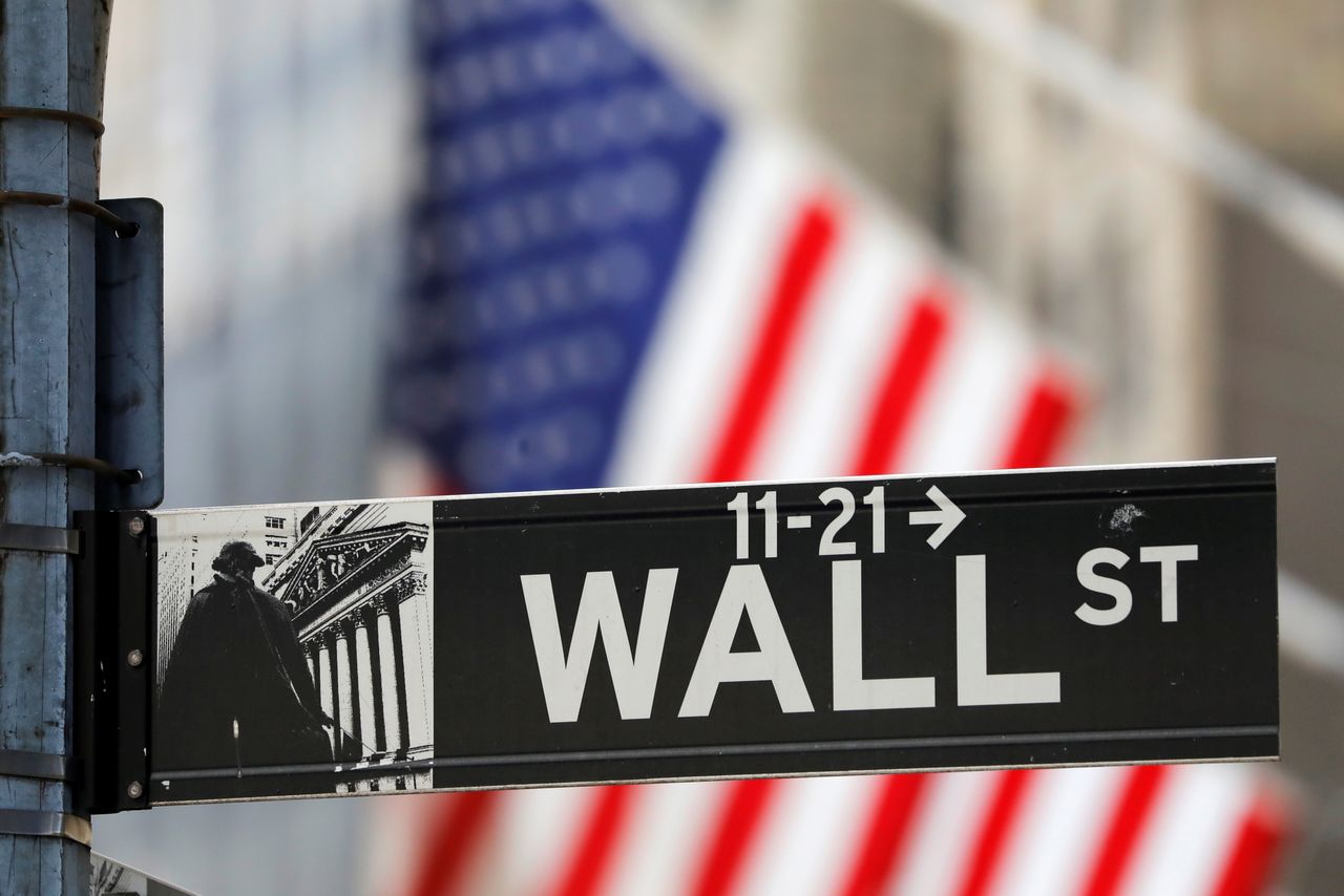 FILE PHOTO: A street sign for Wall Street is seen outside the New York Stock Exchange (NYSE) in New York City, New York, U.S., July 19, 2021. REUTERS/Andrew Kelly
