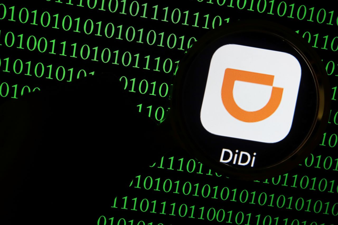 FILE PHOTO: The app logo of Chinese ride-hailing giant Didi is seen through a magnifying glass on a computer screen showing binary digits in this illustration picture taken July 7, 2021. REUTERS/Florence Lo/Illustration