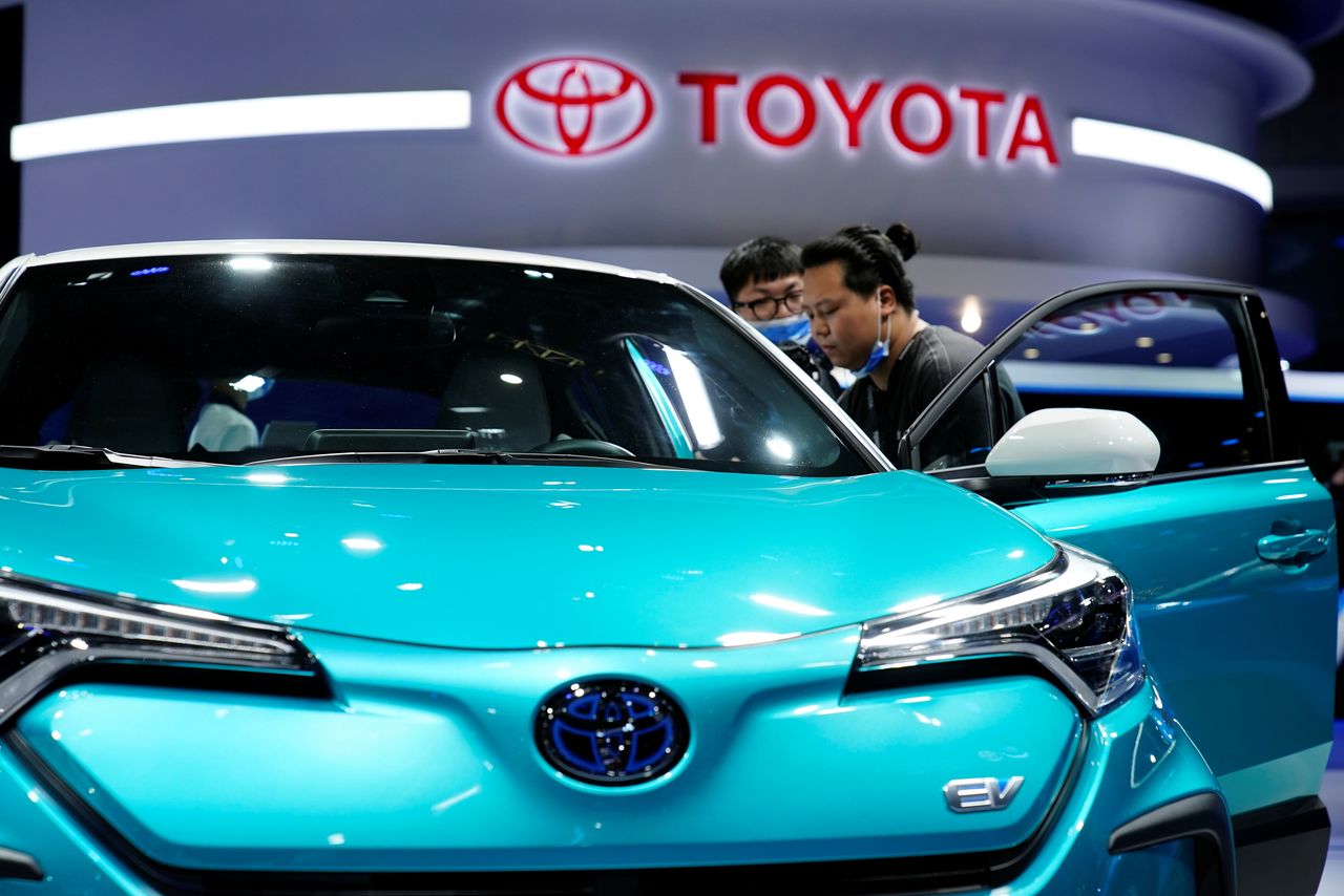 FILE PHOTO: Visitors check a Toyota C-HR electric vehicle (EV) during a media day for the Auto Shanghai show in Shanghai, China April 19, 2021. REUTERS/Aly Song