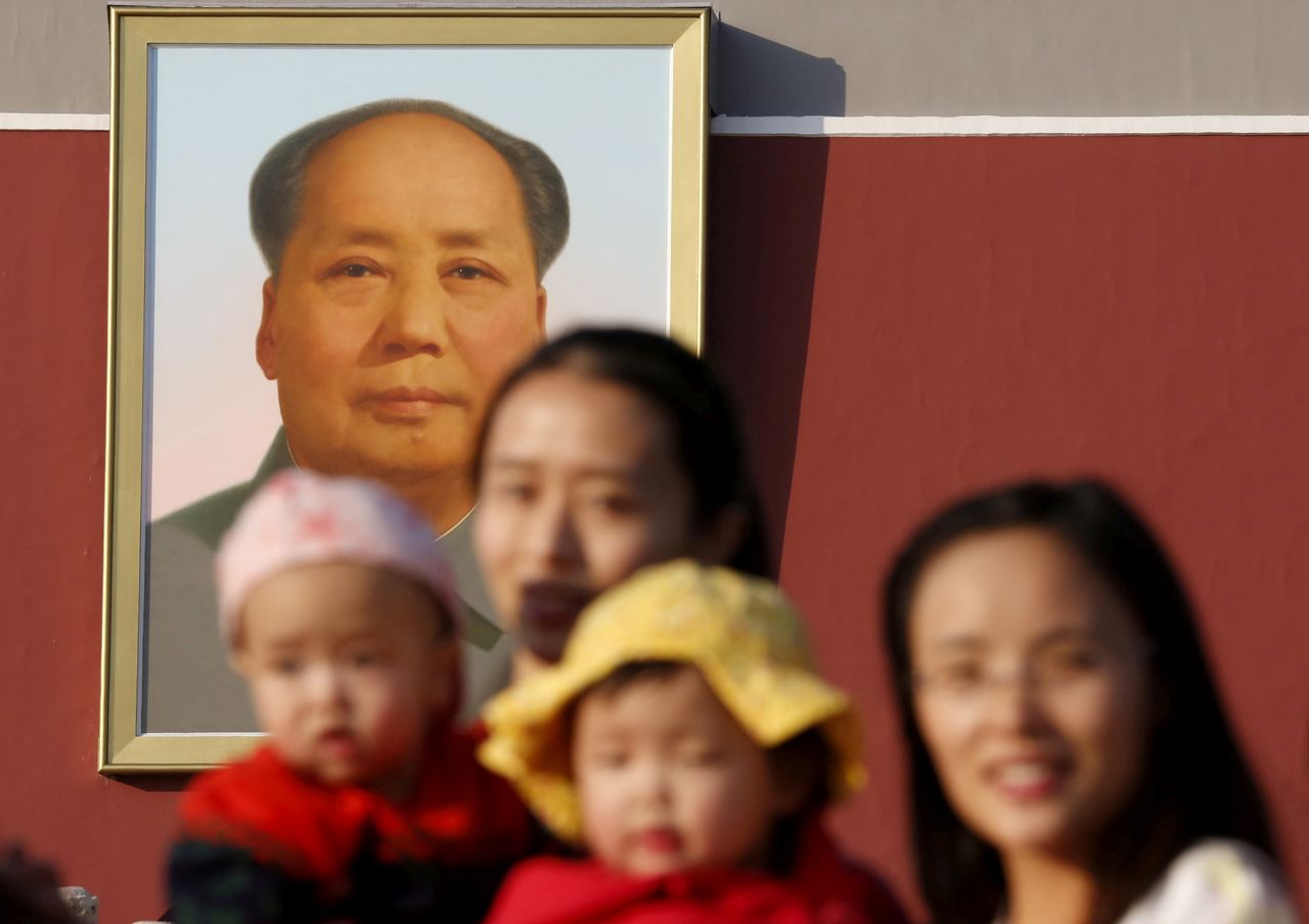 FILE PHOTO: Two women and their babies pose for photographs in front of the giant portrait of late Chinese chairman Mao Zedong on the Tiananmen Gate in Beijing November 2, 2015.  REUTERS/Kim Kyung-Hoon/File Photo
