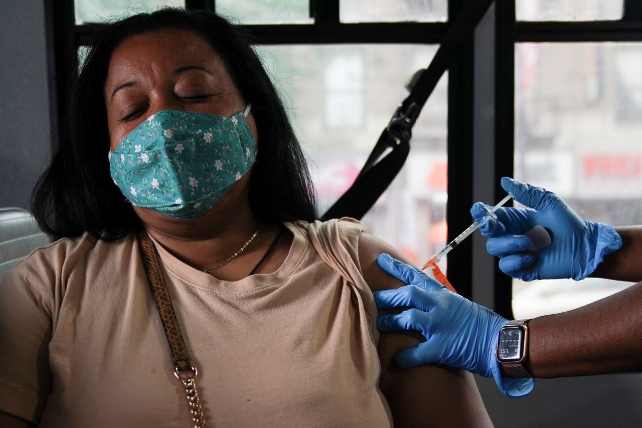 FILE PHOTO: A person receives a dose of the Pfizer-BioNTech vaccine for the coronavirus disease (COVID-19) at a mobile inoculation site in the Bronx borough of New York City, New York, U.S., August 18, 2021.  REUTERS/David 