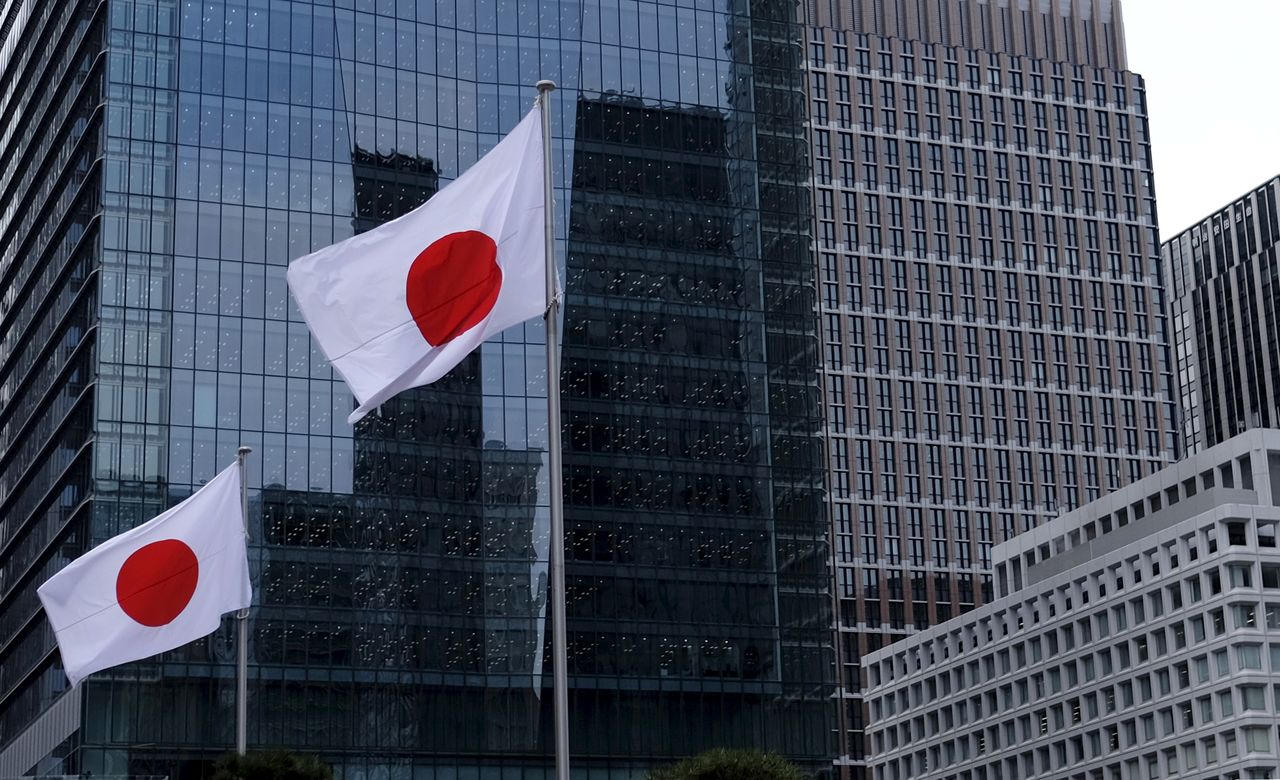 FILE PHOTO: Japanese national flags flutter in front of buildings at Tokyo